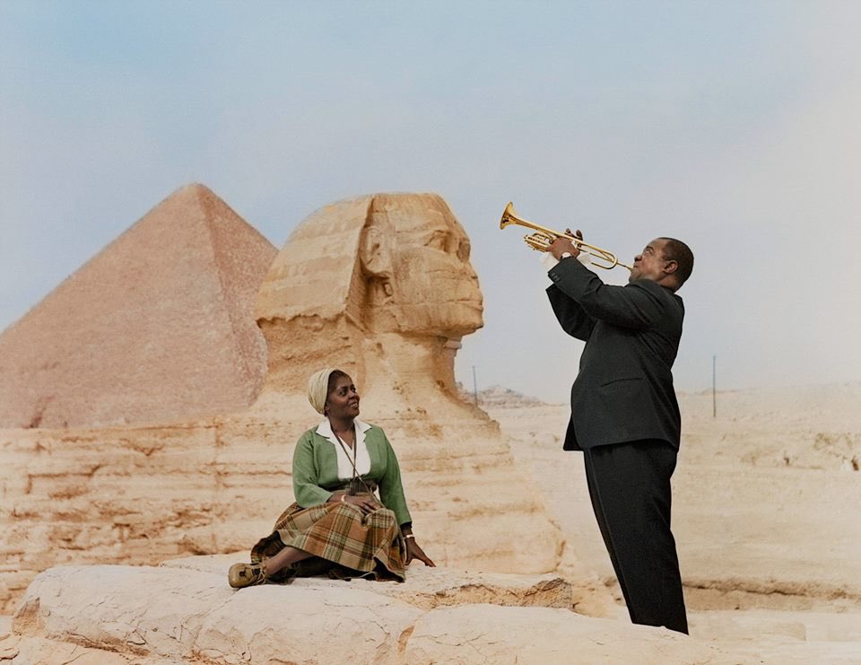 Louis Armstrong playing for his wife Lucille, in front of the Sphinx, Egypt, 1961.