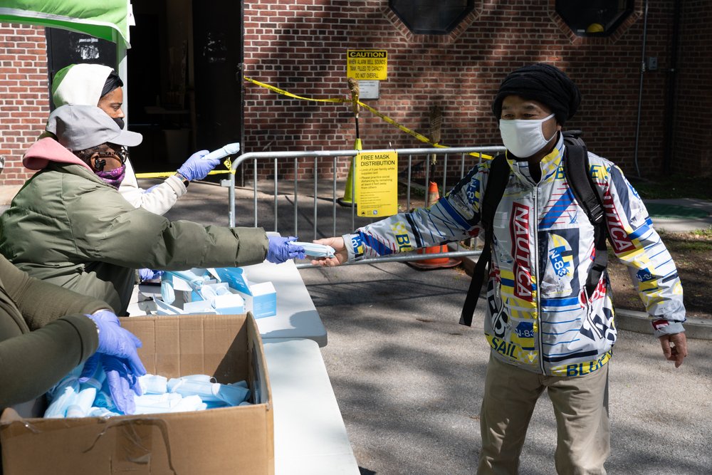 Photo of volunteers giving out face masks during the COVID-19 pandemic in New York City.