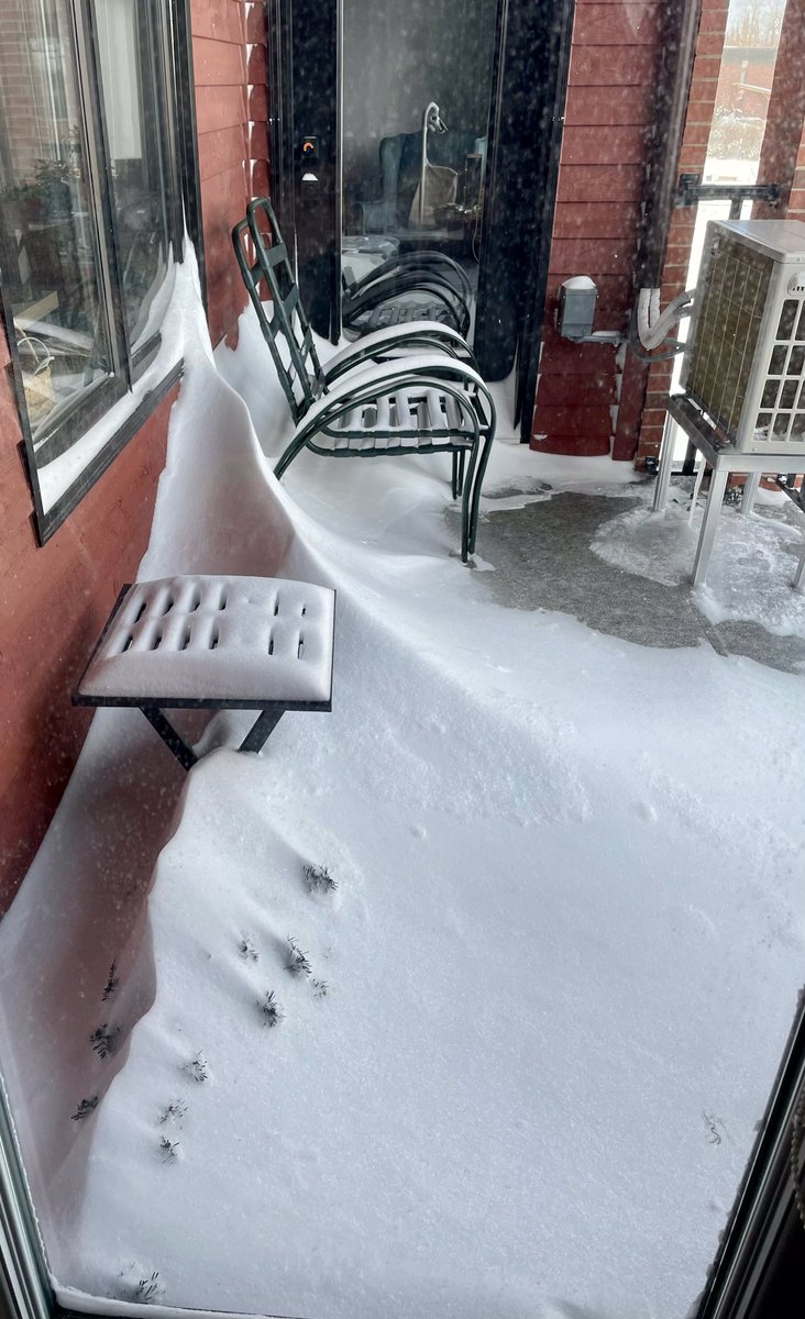 1oceansoul's tweet photo. My balcony furniture stands in vigil waiting for yesterday’s snow to disappear & the bitter temps to end, & remains ever hopeful that spring will once again return this year. And yes, there is a small artificial tree lying under the snow. #WaitingForSpring #NBWinter #IMissSummer https://t.co/9QKHn7wACn