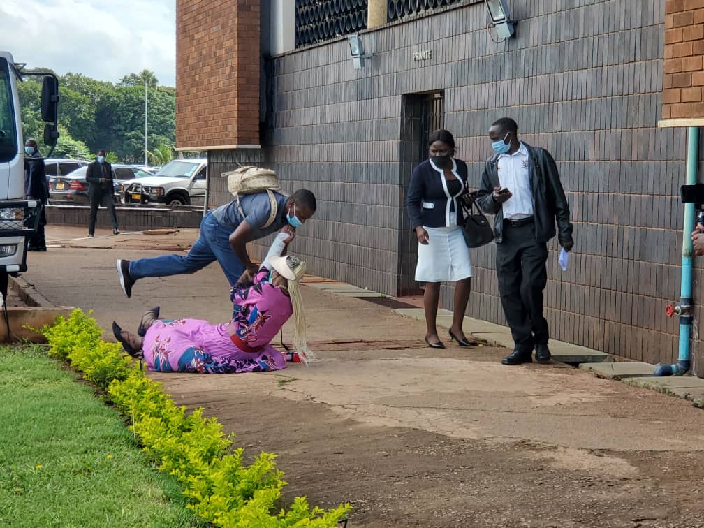 zimlive's tweet photo. DISTRESS: Marry Chiwenga earlier collapsed outside court before being helped back to her feet. Her trial continues over claims that she secretly planned her wedding to VP Chiwenga. NPA seeking to introduce witness statement of dead man, Michael Louzidis, defence challenging https://t.co/CXHJxqRFIy