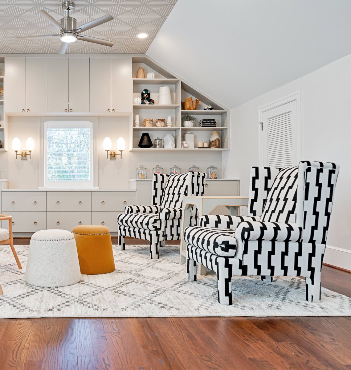 Loving everything about this Boho Playroom Design we completed for our client in Haverford, PA ✨These amazing custom black &amp; white high back chairs &amp; boucle poofs create a fun &amp; funky sitting area tying in key design elements seen throughout this space‼️