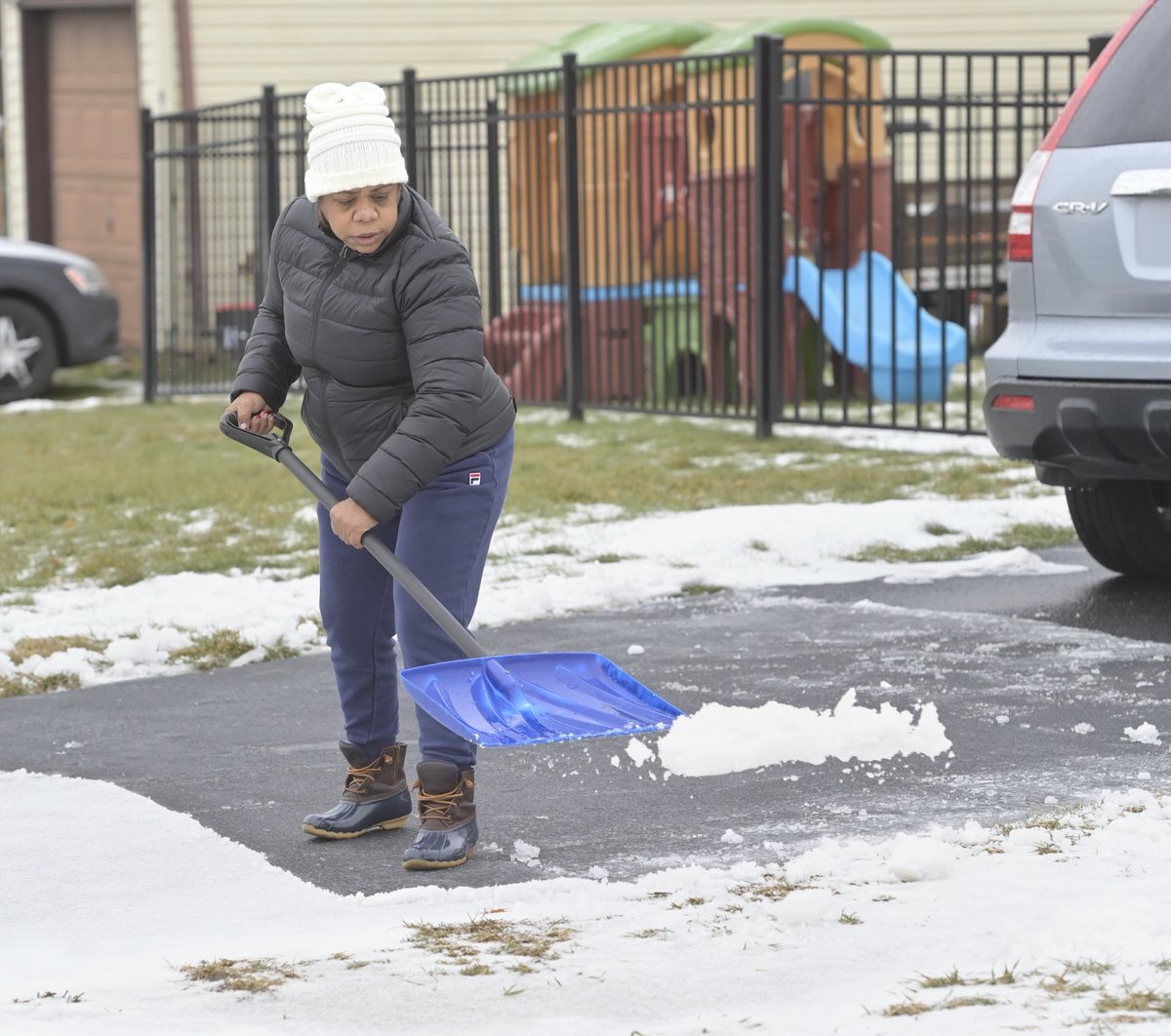 Sandra Ramos shovels slush from her driveway along the 100 block of Pitney Road in Lancaster. ⁦<a href="/LancasterOnline/">LNP | LancasterOnline</a>⁩