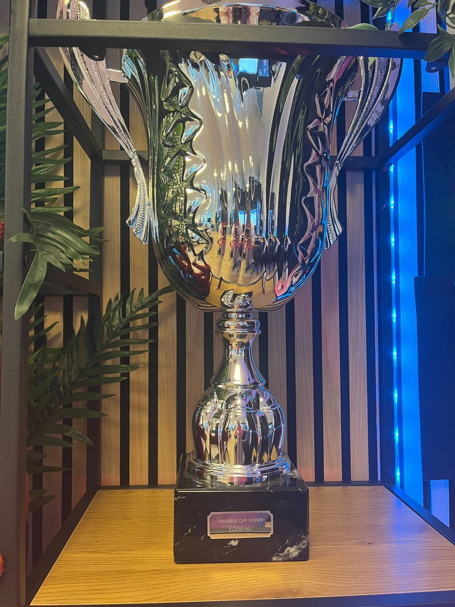 PlayEmberSword's tweet photo. The Thanabus Cup🏆 now proudly displays Ediseau's name! Congratulations again to the winning nation and all of its wonderful denizens⭐

P.S. We could barely keep Whiskers away from it. No matter where we move him, he keeps appearing next to it. https://t.co/RZkFNntcFG