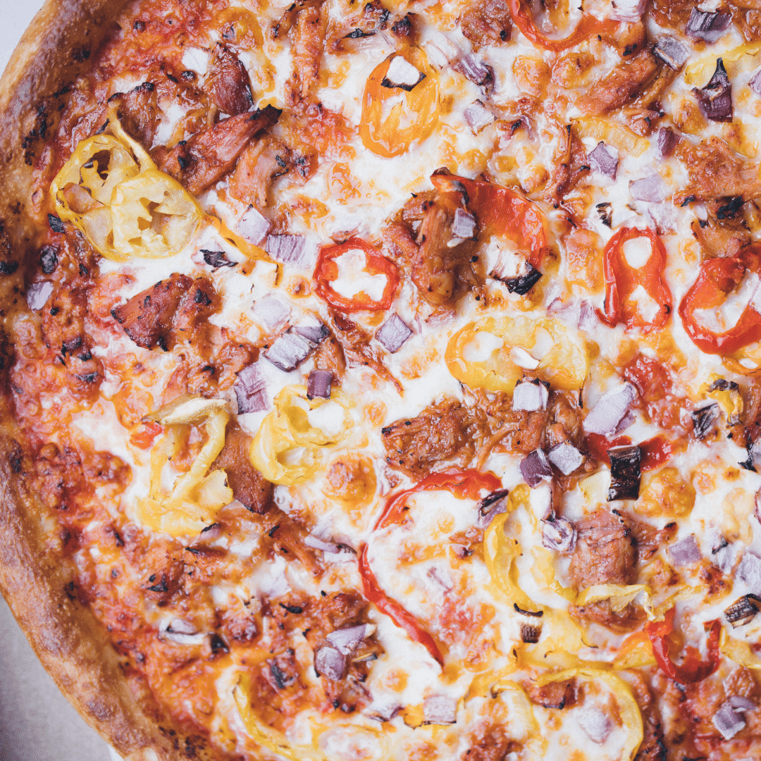 Turning up the heat 🔥 with our BBQ Pulled Pork Pizza!. Tangy BBQ Pulled Pork with Banana Peppers