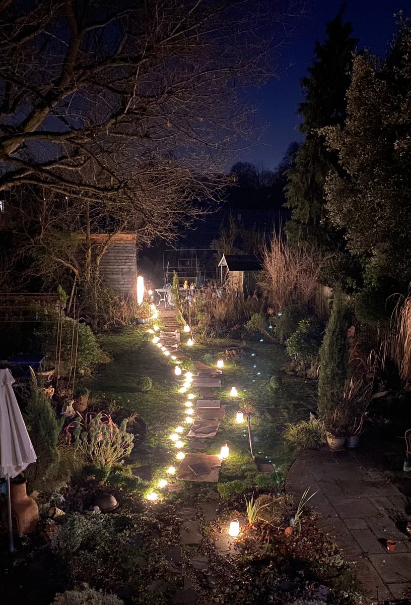 theremaybebugs's tweet photo. My garden looked magical this evening. A dear friend ran a #MoonCircle in my Atelier. I wanted to protect the lawn so lay a cardboard and board path and thankfully had enough spare lighting to illuminate said path for safely. And my iPhone took a lovely photo of it! https://t.co/aLkFWyjWGD