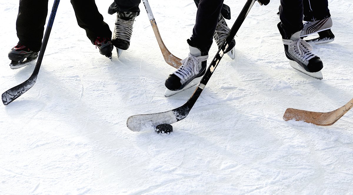 2 hockey to play in winter. Ice hockey outside. hockey to play in winter. hockey team children outside. the boys like to play hockey skating rink.