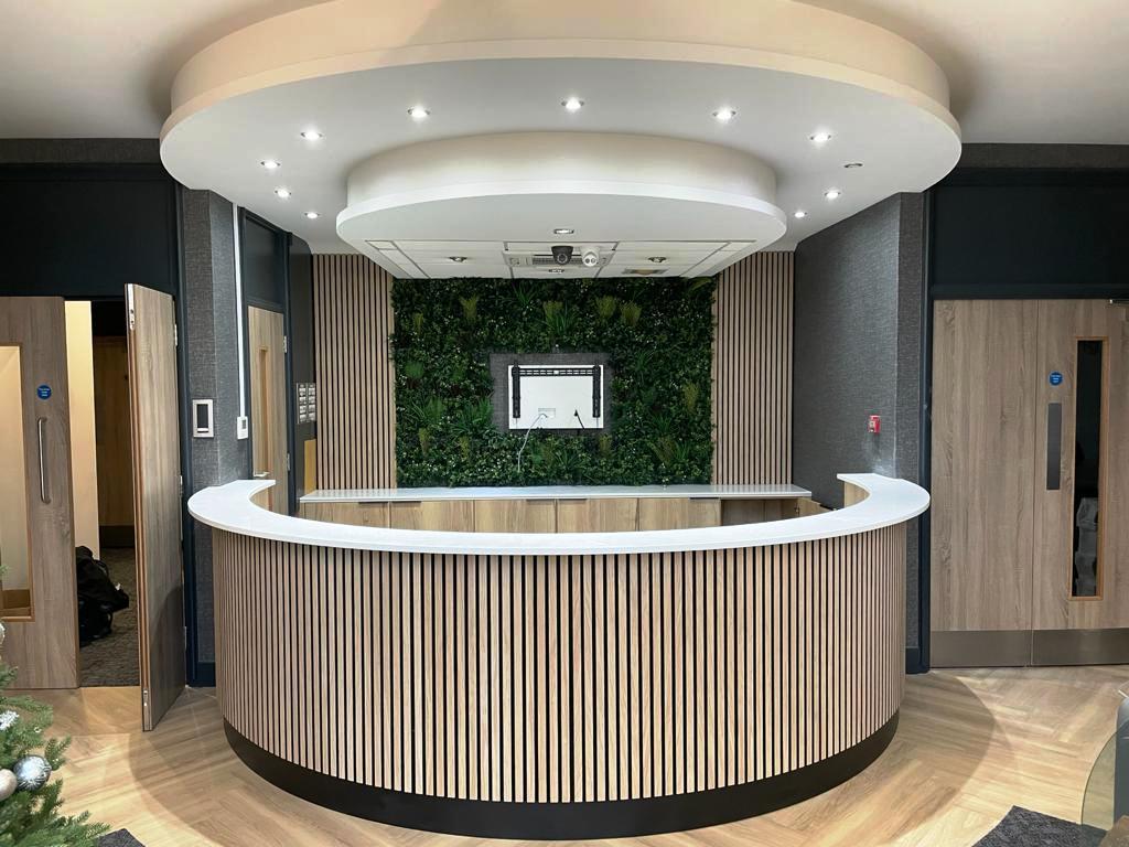 Another bespoke #receptioncounter manufactured and installed by LiDR for The Interior Design Practice. The curved shape mirrors the bulkhead above &amp; our back fitting accommodates a living wall which helps to bring the outside in. #ukmanufacturer #bespokefurniture #receptiondesk