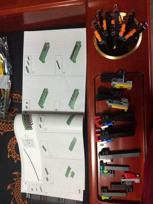 A bunch of random gears of Legos put together with instruction booklet open to bag "2" section