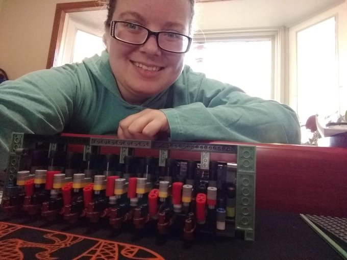 A selfie with me showing off the gears all lined up on the 4 stick things, the beginnings of typewriter mechanics