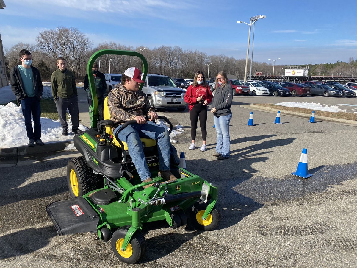 Landscape class explorers operating commercial mower on a course.
