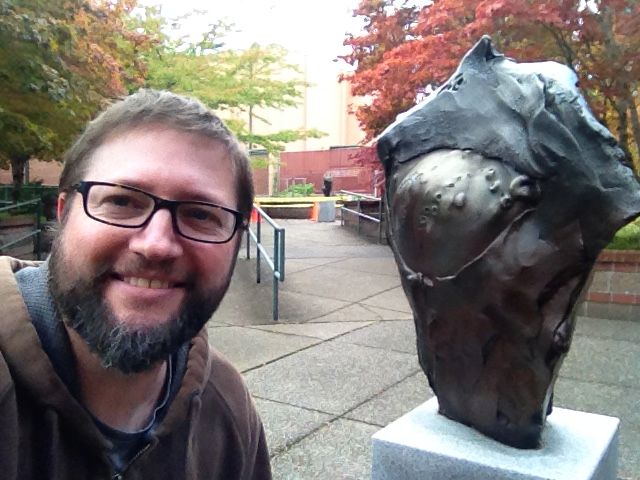 ArtsWA's tweet photo. #MuseumSelfieDay: ArtsWA Conservation Manager Adam Fah with “Raven Stele” by Frank Boyden. Bronzes are close to Adam’s heart as he is also a patineur. Located at South Puget Sound Community College, Olympia. https://t.co/kgOyetoevi #WAStateArtCollection #ArtsWAMyPublicArtPortal https://t.co/ttBJLgrjaf