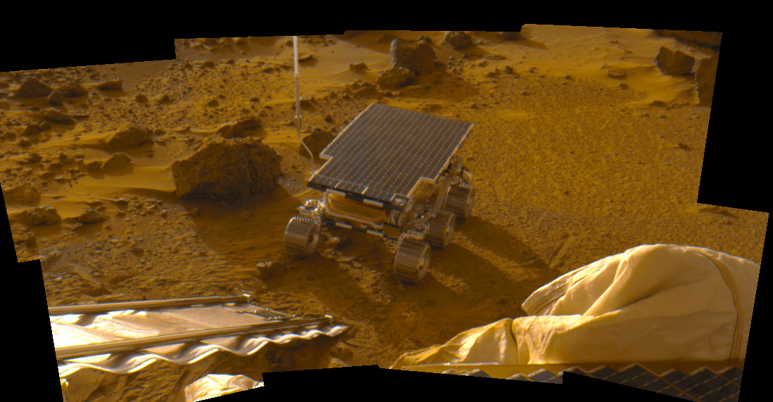 Da Sojourner rover wit its flat solar pannel back, six wheels, n' two lil' small-ass cameras on tha surface of Mars.