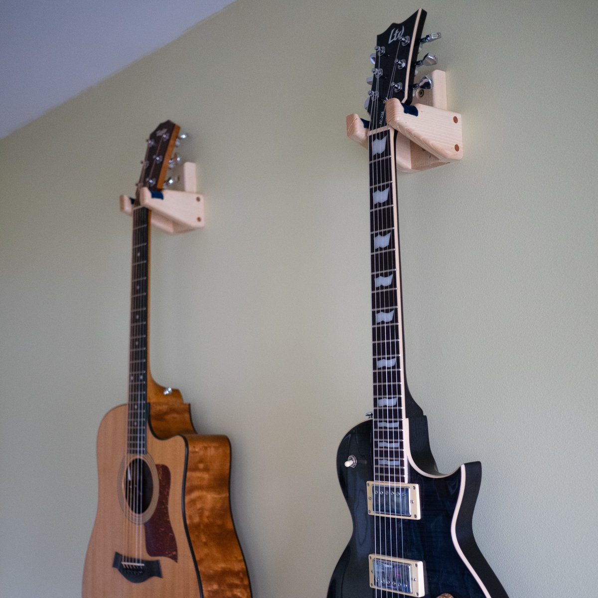 c_had's tweet photo. My latest little project - guitar hangers. Made of Hickory with Cherry accents with velvet padding. I hung them on the wall in my office, so now I have easier access to my guitars whenever I want to play. https://t.co/4avFAl96AY