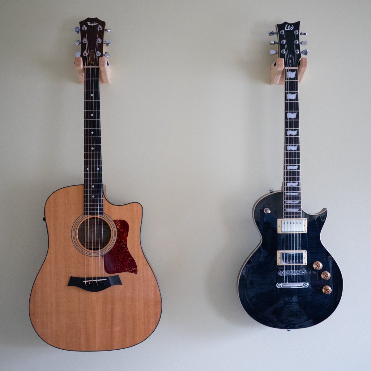c_had's tweet photo. My latest little project - guitar hangers. Made of Hickory with Cherry accents with velvet padding. I hung them on the wall in my office, so now I have easier access to my guitars whenever I want to play. https://t.co/4avFAl96AY