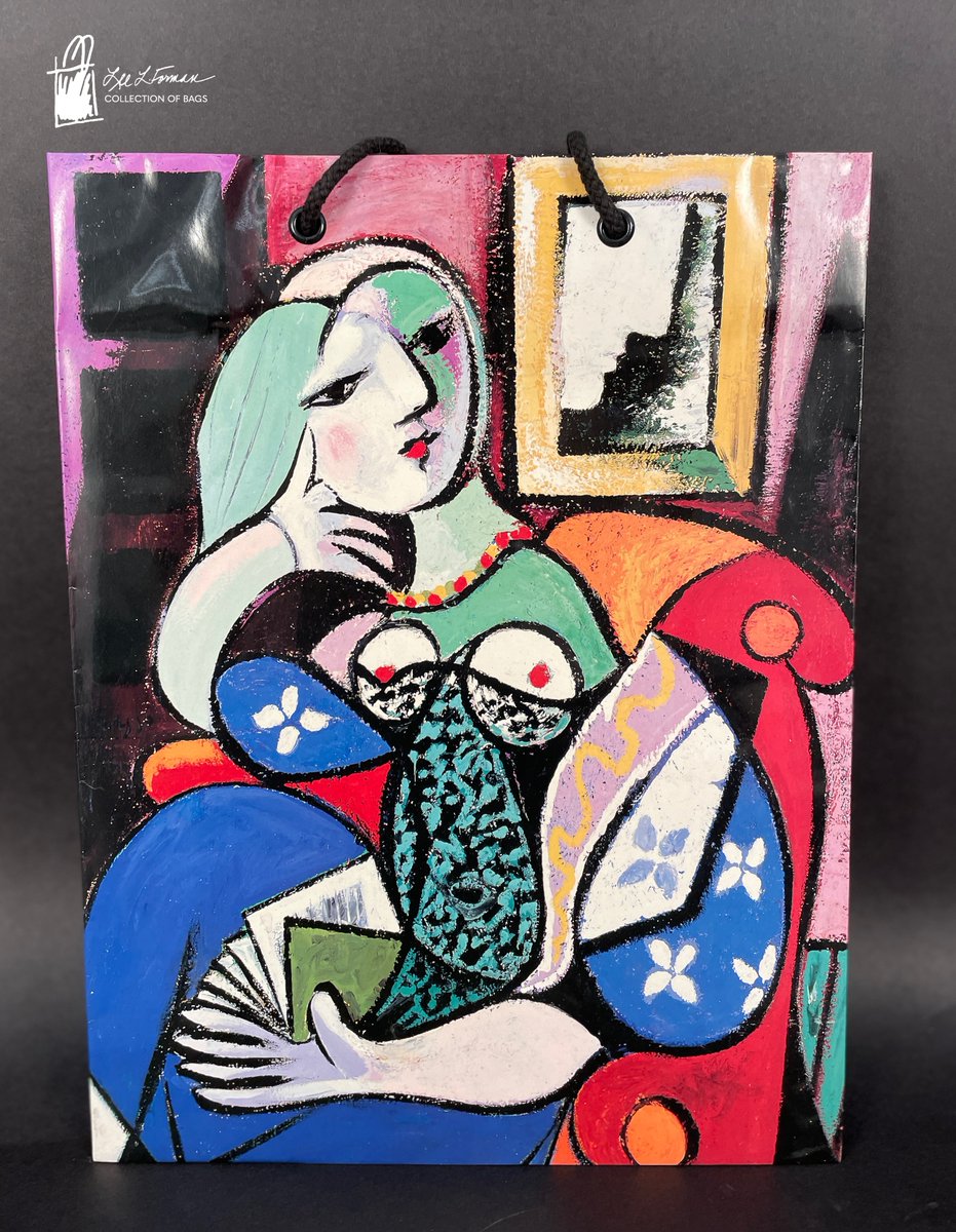 22/365: In this reproduction of Picasso's Woman with a Book,  Marie-Thérèse Walter is featured sitting in a bright armchair with a book opened on her lap. Behind her, a mirror reflects an undefined profile.