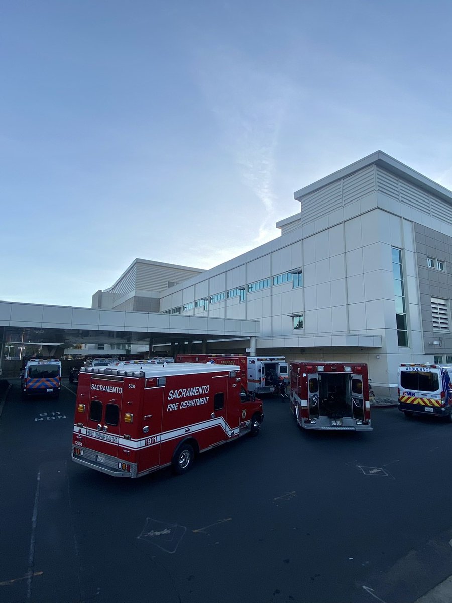 metrofirepio's tweet photo. Yesterday at 4:30pm, 18 ambulances were parked at UC Davis with patients waiting on the hospital wall for a bed. This creates a major problem for the pre-hospital 911 system because there are fewer units a available to respond. @CNN @FoxNews @NBCNews @MSNBC @CBSNews @BBCWorld https://t.co/QvhuJwDlM0