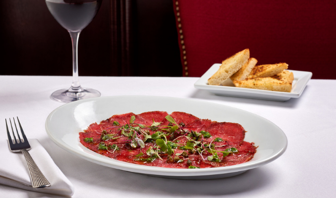 Tonight is the perfect night to try our Beef Carpaccio: thinly sliced blackened filet, served with arugula pesto, crispy capers, and toast points.