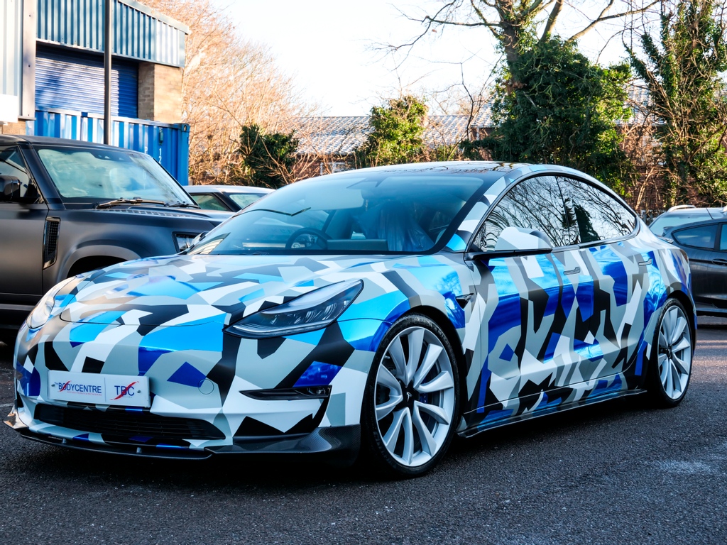The_Bodycentre's tweet photo. The Digital Camo wrapped Tesla Model 3 we completed in March last year has now had its winter make over  ❄️🥶🧊

We absolutely love it! What do you guys think? 

#teslamodel3 #tesla #wrappedtesla #vinylwrap #digitalcamo #autobodyshop #vehiclecustomisation https://t.co/D4JBntN2Be