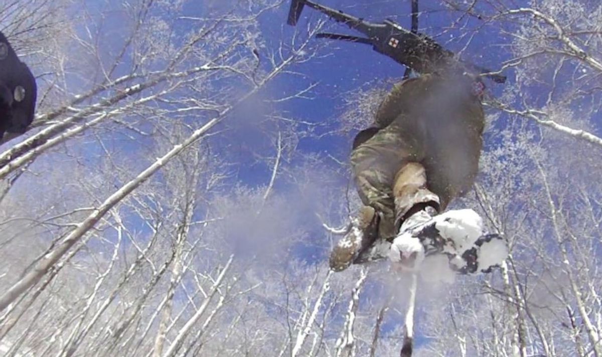Sgt. 1st Class Tracy Banta, a Critical Care Flight Paramedic with the Tennessee National Guard, is hoisted to a UH-60 Blackhawk helicopter after rescuing a stranded hiker on the Appalachian Trail, Jan. 18.