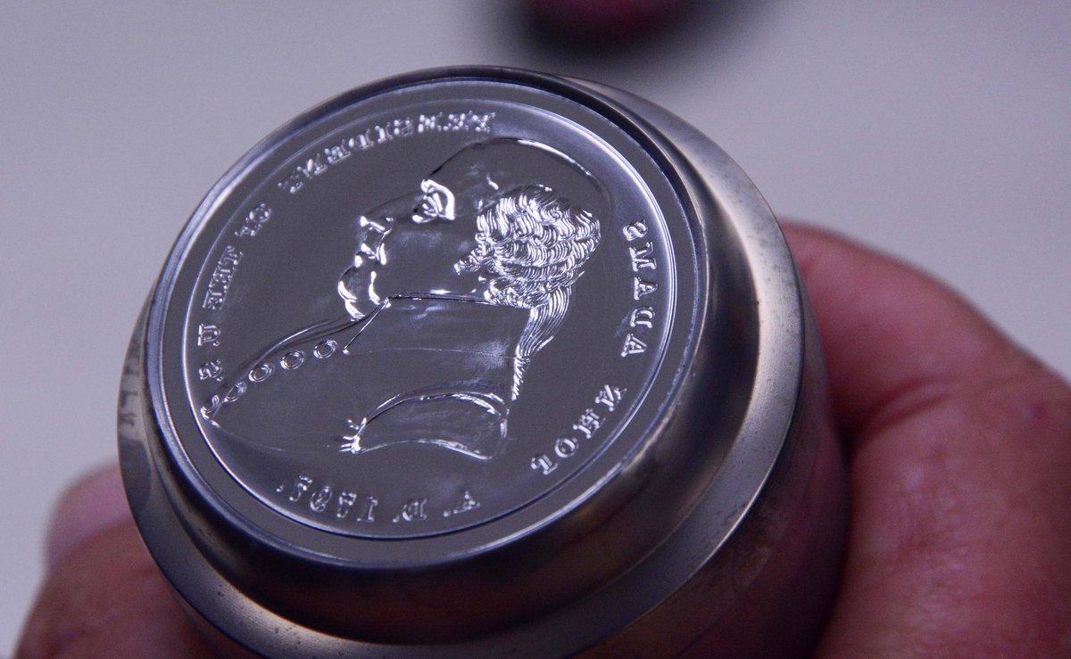 usmint's tweet photo. In the die making process, the U.S. Mint makes several generations of hubs and dies. Hubs show a positive image the way the artist created it. Dies are like a photo negative, displaying the design in reverse. Learn more about our production process at https://t.co/ra4l31kprw. https://t.co/lagkMmjLmu