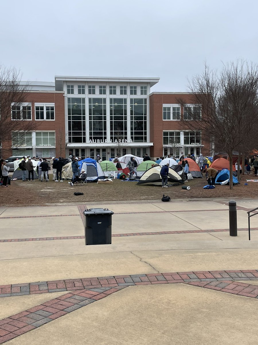 henryzimmer's tweet photo. A small community has formed outside of Auburn Arena. Students are doing homework, on Zoom, crushing Chik Fil A. Somebody is playing Pushin P. 24 hours to tip. 37 degrees outside. https://t.co/fQvV62XK5P