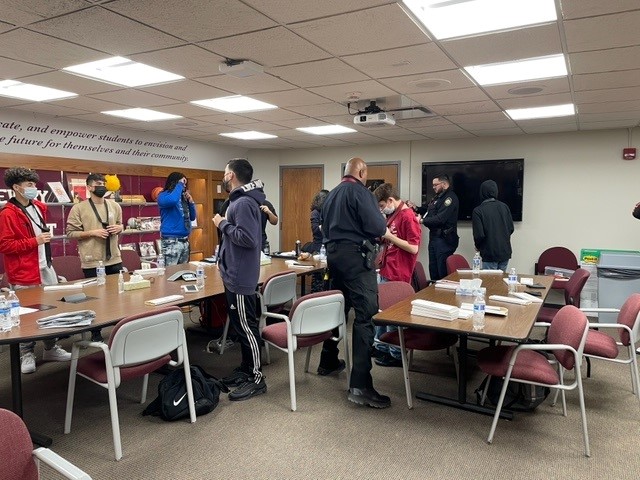 ArgoDeans's tweet photo. SRO Antoine (Bedford Park Police Department) and SRO Snee (Summit Police Department) teaching life skills to their young men’s group.  Each student was taught how to tie a tie and given a tie to take home.  #Argopride #Welldressed #Lifeskills https://t.co/s0cmZYmOlX