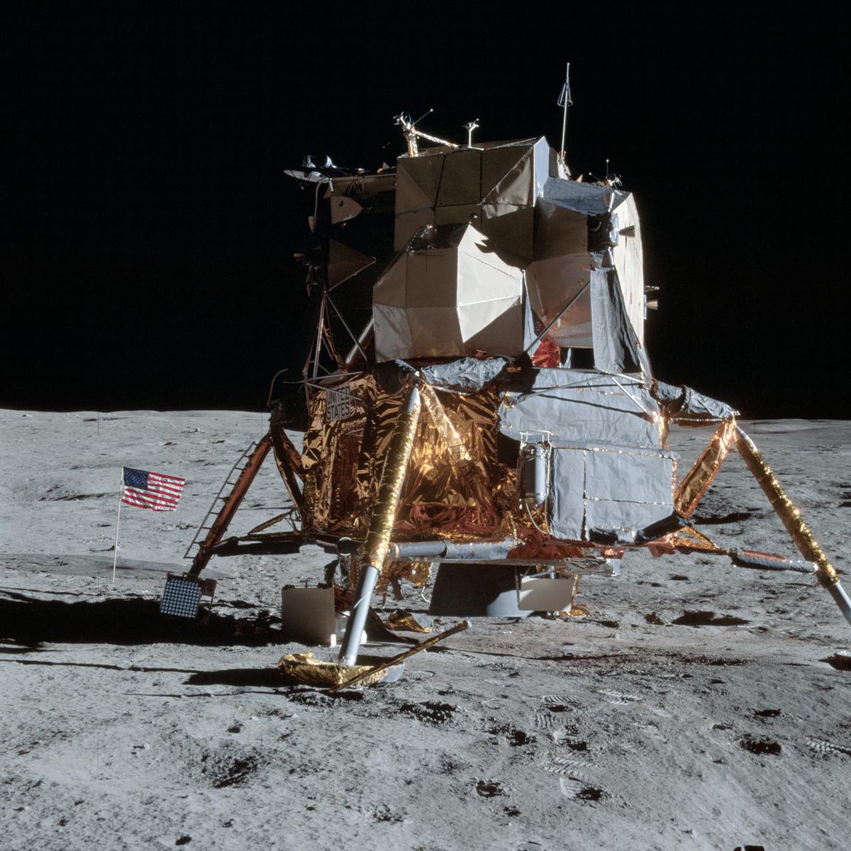 View of Apollo 14 Lunar Module on tha Moon. I aint talkin' bout chicken n' gravy biatch fo' realz. A US flag n' laser rangin retro reflector sit ta tha left of tha spacecraft on tha lunar surface.