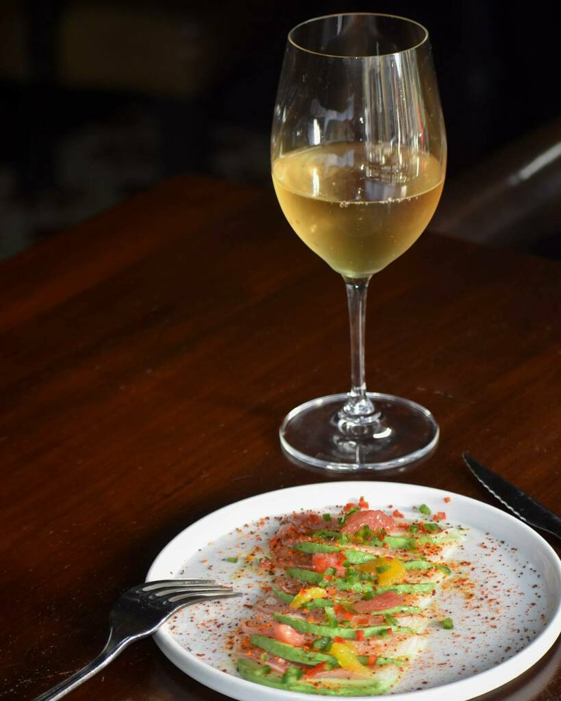This yellowtail crudo is an ethereal pairing with our Eric Kent #sauvblanc 

Fresh yellowtail crudo, dressed with yuzu lemon 🍋, ponzu, and topped with avocado &amp; mandarinquat morsels. 😋

#bottleorglass #lgohospitality #yum