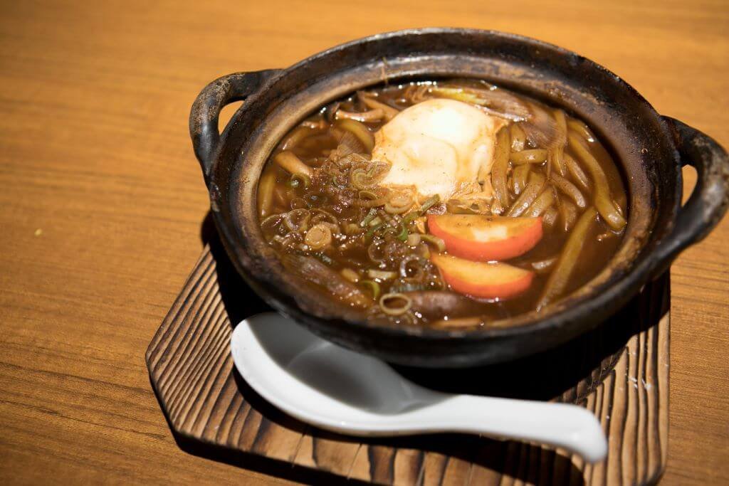 Miso nikomi udon is a dish of thick udon noodles cooked in a thick broth made from bonito dashi 