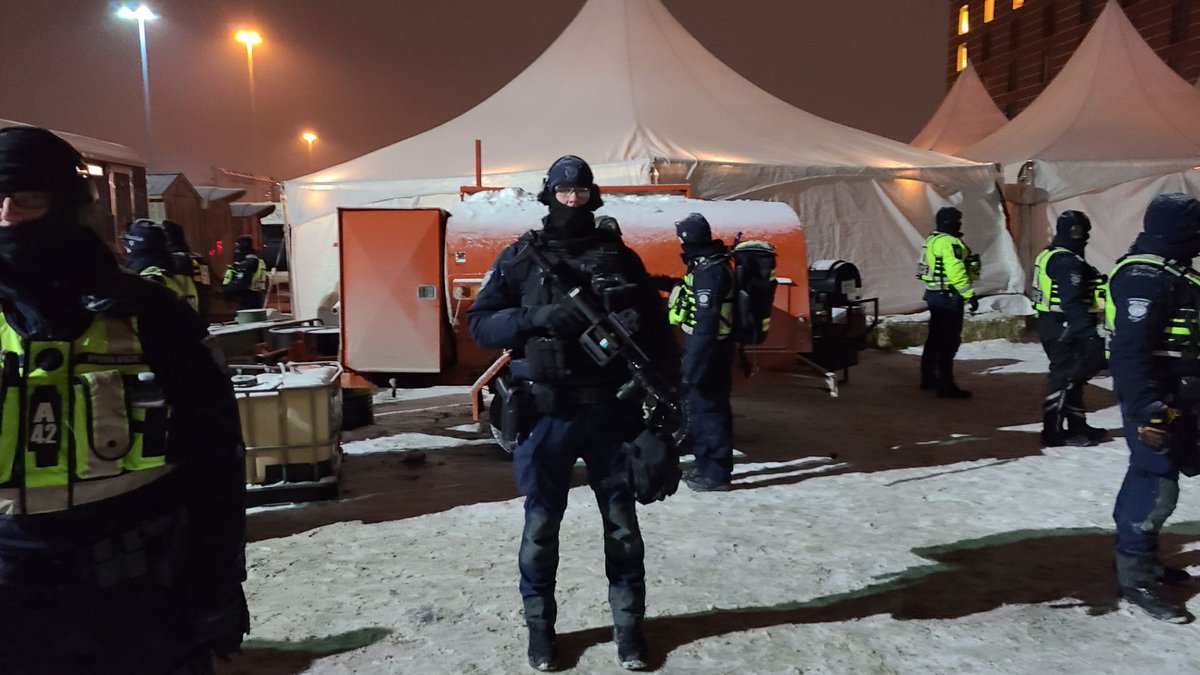 DukeMarcude's tweet photo. This is not our Canada. 
Tactical units surrounding the trucker's camp tonight in Ottawa. https://t.co/BLDKzIEups