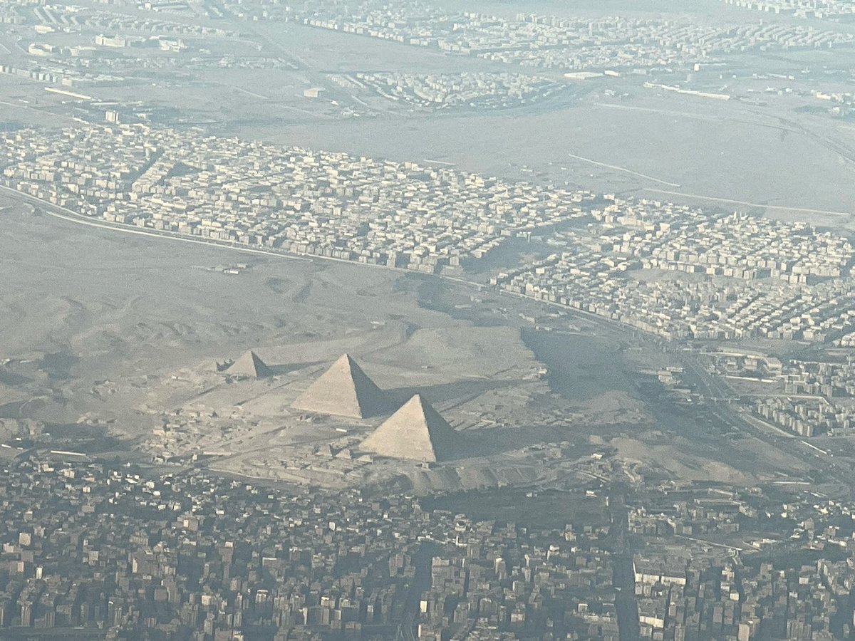 Pilot_Holly's tweet photo. Someone on our flight shared this wonderful picture with me, which was snapped by them as we flew out of Cairo, Egypt, on Thursday! Wow. They took a great shot! #ancientwonderoftheworld #pyramids #cairo https://t.co/WTHyZGXcP1