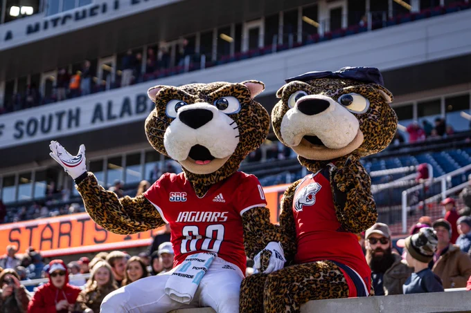 SouthPaw and Ms Pawla pose on the stadium wall before the Senior Bowl starts 