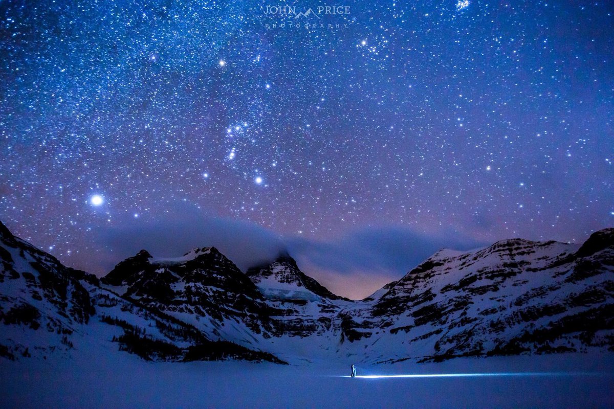 Skiing under a bright blanket of stars under Mt Assiniboine.