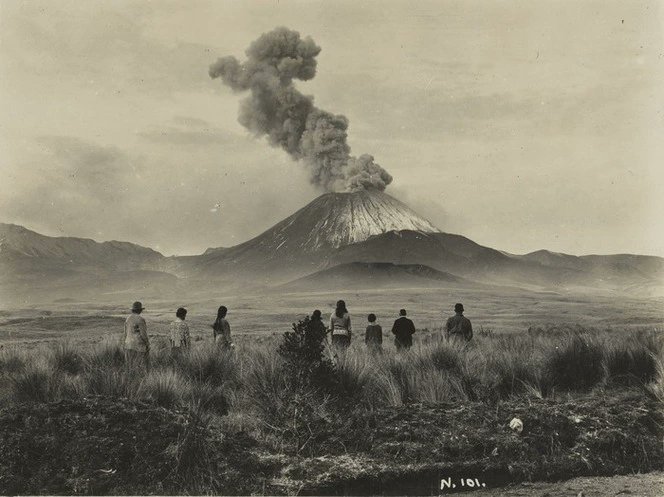 A group of people watching the eruption of Mount Ngauruhoe, on the Central Plateau of the North Island. Photo taken in 1926. Source: National Library of NZ