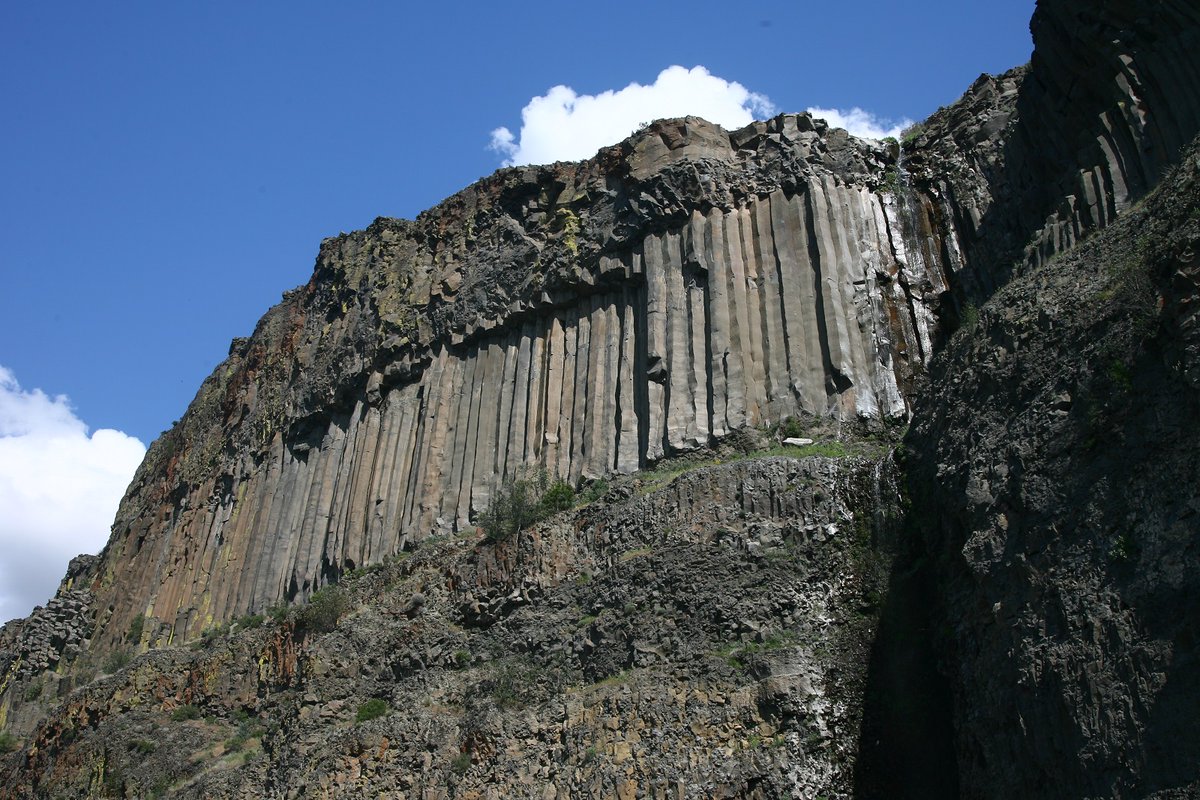 A towering cliff of dark rock.