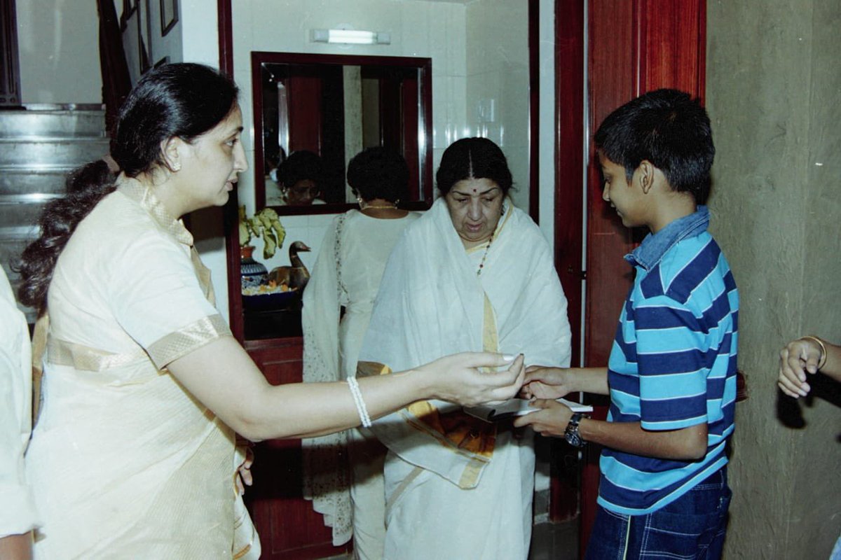 A cherished moment from my childhood. Lata tai's presence had a divine quality, just like her voice. All of us have been touched by her music. But it is a special feeling to have had the privilege of meeting her and seeking her blessings in person. Tai, you will be dearly missed.