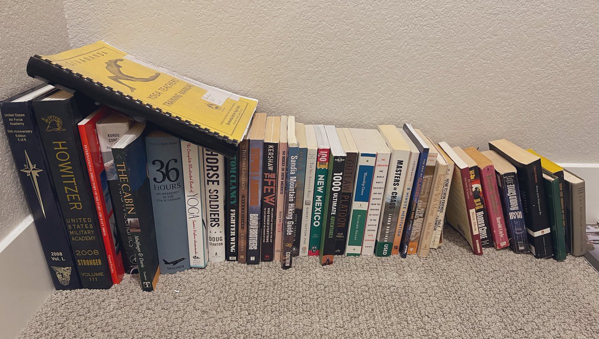 Doing a bit of organizing this weekend. A person's books collected over the years can tell an interesting story. What does your collection look like? 📚🧘‍♀️🪖⚽️🥾#fluidmechanicsisdefinitelymyhusbands #veteranyogitrailblazer #pcsseason