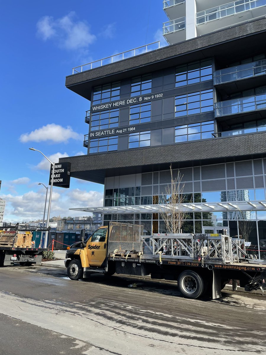 pgcornwell's tweet photo. The massive apartment buildings (rent: $2500+) going up in the former Seattle Times parking lot (RIP) have Times headlines on each floor. If they use any of my stories’ headlines do you think they’ll give me free access to the pools/dog run/climbing wall/karaoke room? https://t.co/jXfRNfTI3V
