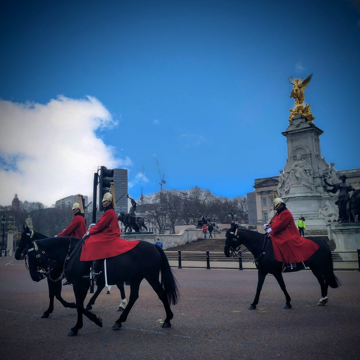 Horse guards riding past Buckingham Palace