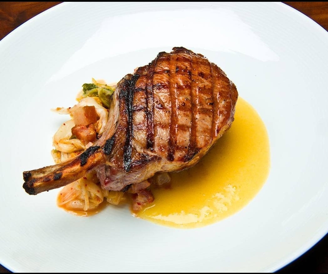 Escape the cold of winter by taking a warm vacation to Maui. When you're there enjoy a tender, juicy pork chop at @morimotomaui! Served with kimchee, bacon, and ginger apple puree. Are you ready for dinner yet?