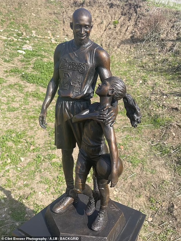 DailyMailCeleb's tweet image. The basketball legend and his daughter have been immortalized with a bronze statue with the inscription 'heroes come and go but legends are forever'