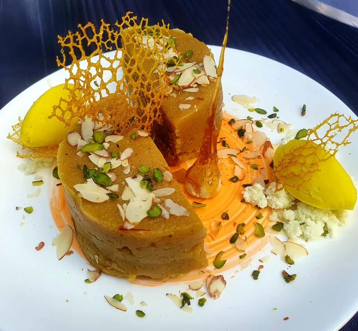 MasterChefIrfan's tweet photo. Mohanthal is an Indian sweet made with besan (gram flour), ghee, sugar and flavored with cardamom and saffron. It has a grainy texture. Basically Mohanthal is a traditional Gujarati sweet dish but It is also made in Rajasthan. #masterchefirfankhan #sweet #food #WAMC @ranveerbrar https://t.co/8KTLtFWC6m