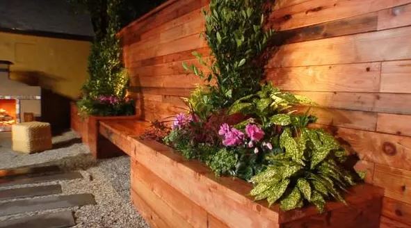 A custom wooden flower box like the one in this example can help you overcome the challenge of limited planting space. Choose plants that add color, texture, and fragrance to your space.