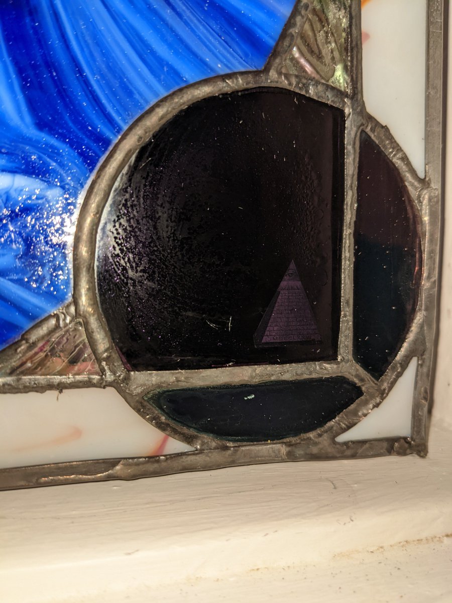 bitficus's tweet photo. "Third Block from the Sun" 

Really happy with how this turned out. Tried some new tricks, and added some small details.

#Bitcoin over earth, fiat below. 21 pieces in red/blue vortex. Genesis block small piece on left border. Stained glass made to last 1000 years. 

#bitcoinart https://t.co/72n2bSBuO6