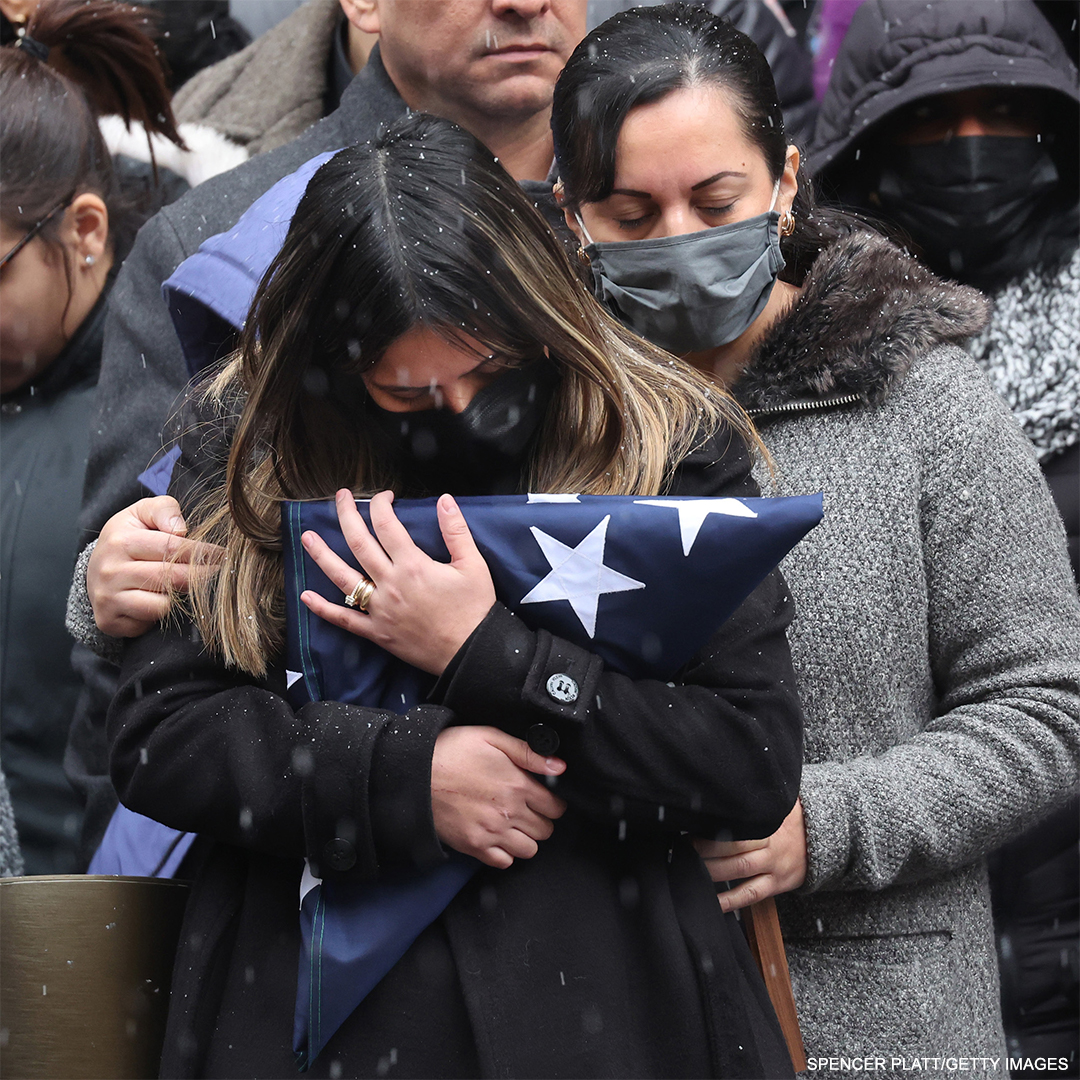 ABC's tweet photo. 📸: Dominique Rivera, wife of slain NYPD Officer Jason Rivera, clutches the flag from his casket while attending his funeral at St. Patrick's Cathedral in New York City. Rivera and his partner were both killed after responding to a domestic violence call. https://t.co/wxCsrmTRDx https://t.co/PNTUoUnYRG