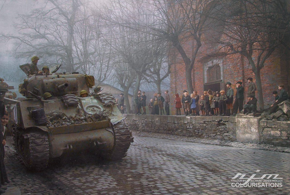 German children watch U.S. Tanks of 87th Division, Third U.S. Army, enter town of Kobern, Germany. March 16, 1945. Kobern, was on the Moselle River five miles southwest of Coblenz.

Colour by RJM