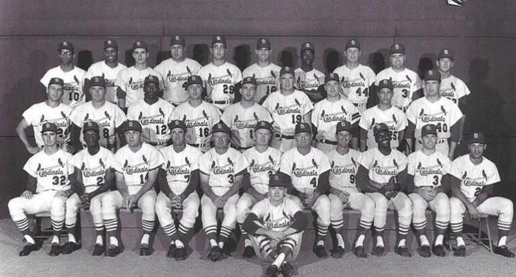 Here’s Bob Uecker and Bob Gibson holding hands in the Cardinals team photo. Nobody caught it. Zoom in on their faces, it’s totally worth it ...