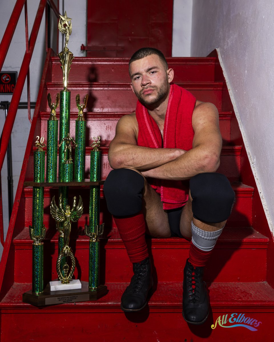 Pro Wrestling Guerrilla's 2022 Battle of Los Angeles winner Daniel Garcia, sitting with his tournament trophy on a red staircase.
