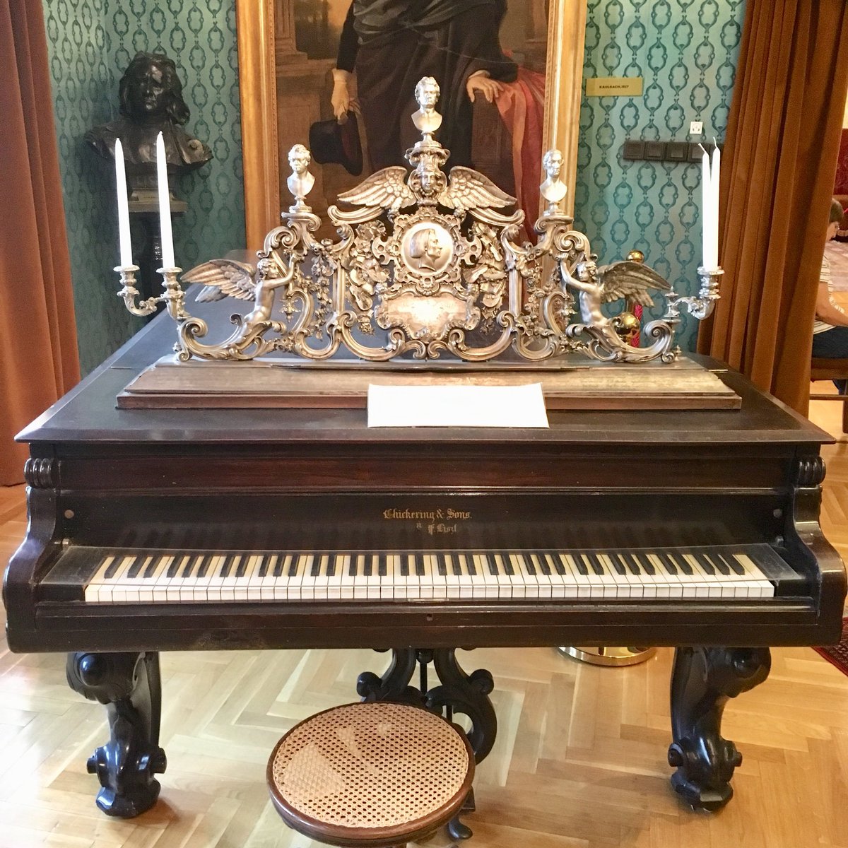 Liszt venerated three idols, from left to right: 

Schubert, Beethoven and Weber.