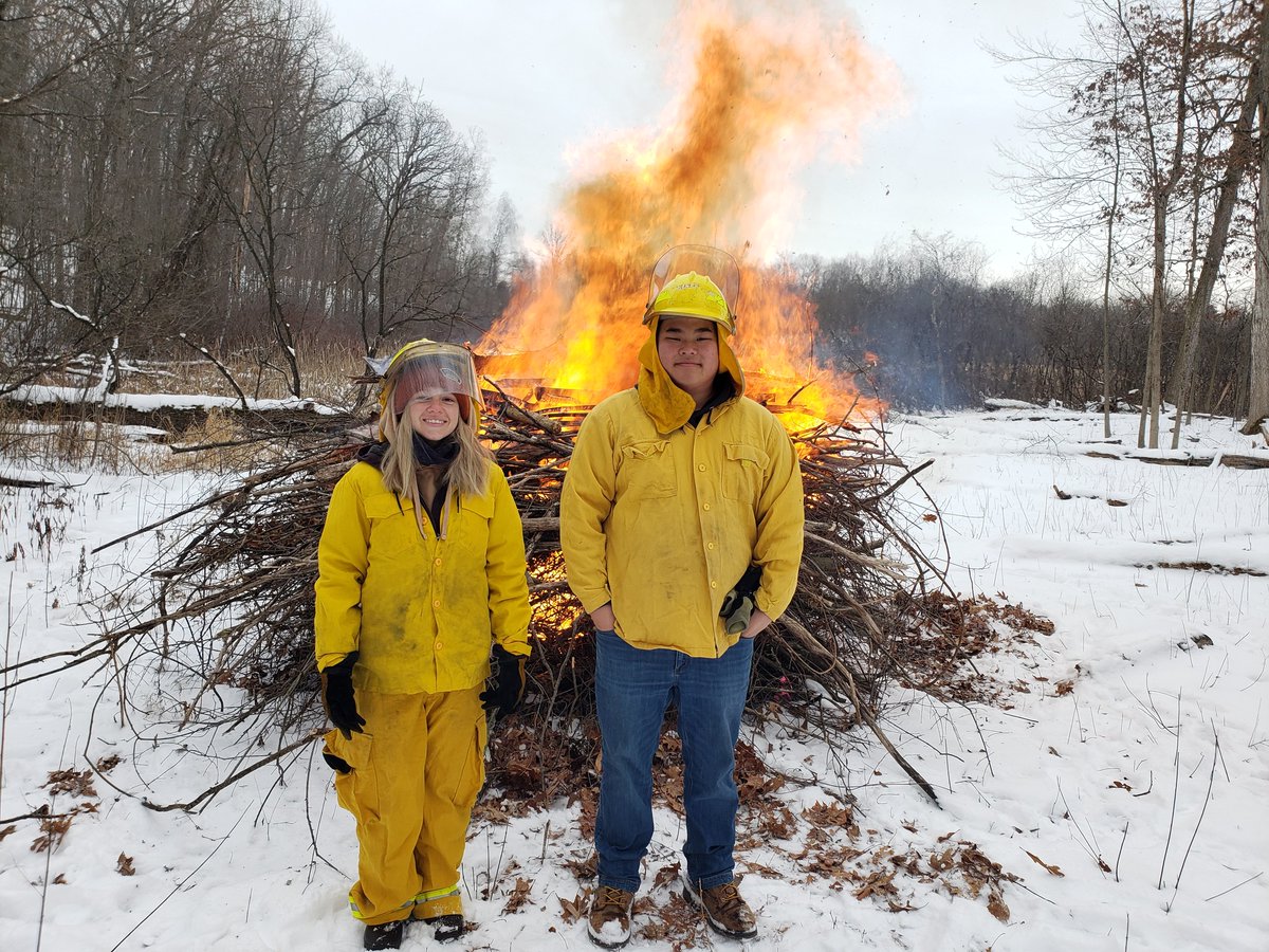SixRivers's tweet photo. Burn buckthorn burn! Six Rivers joined Oakland Township Parks &amp; Recreation  on Thursday to ignite some large brush piles of invasive buckthorn at Bear Creek Nature Park. The shrubs in these piles were cut down at a combined stewardship workday in the fall. #naturenearyou https://t.co/veOVssQd4x